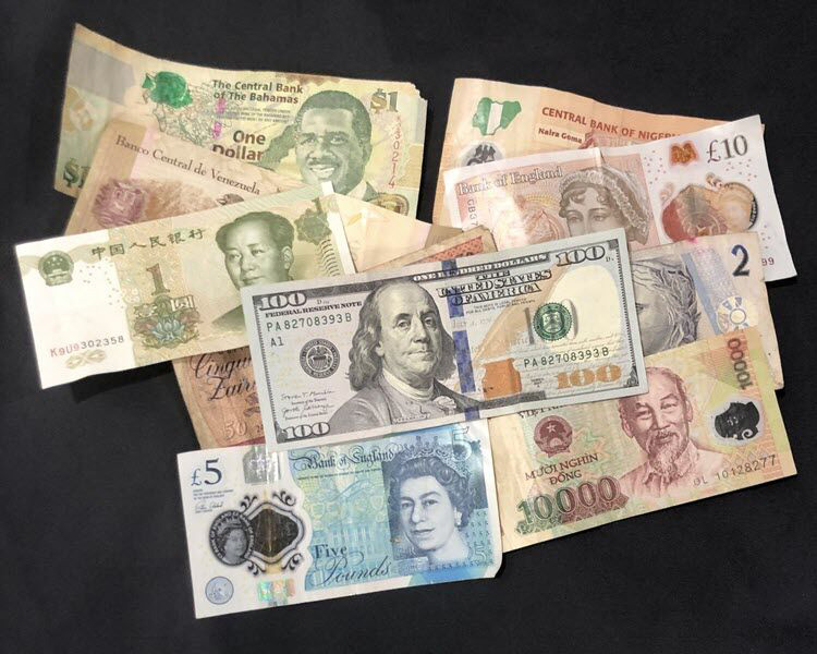 Collection of currencies from the bahamas, brazil, china, nigeria, the UK, the U.S., vietnam and zaire